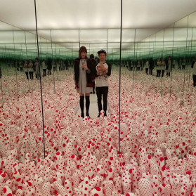 -portrait of a mirror selfie taken inside Yayoi Kusama's "infinite mirrors" exhibit-
